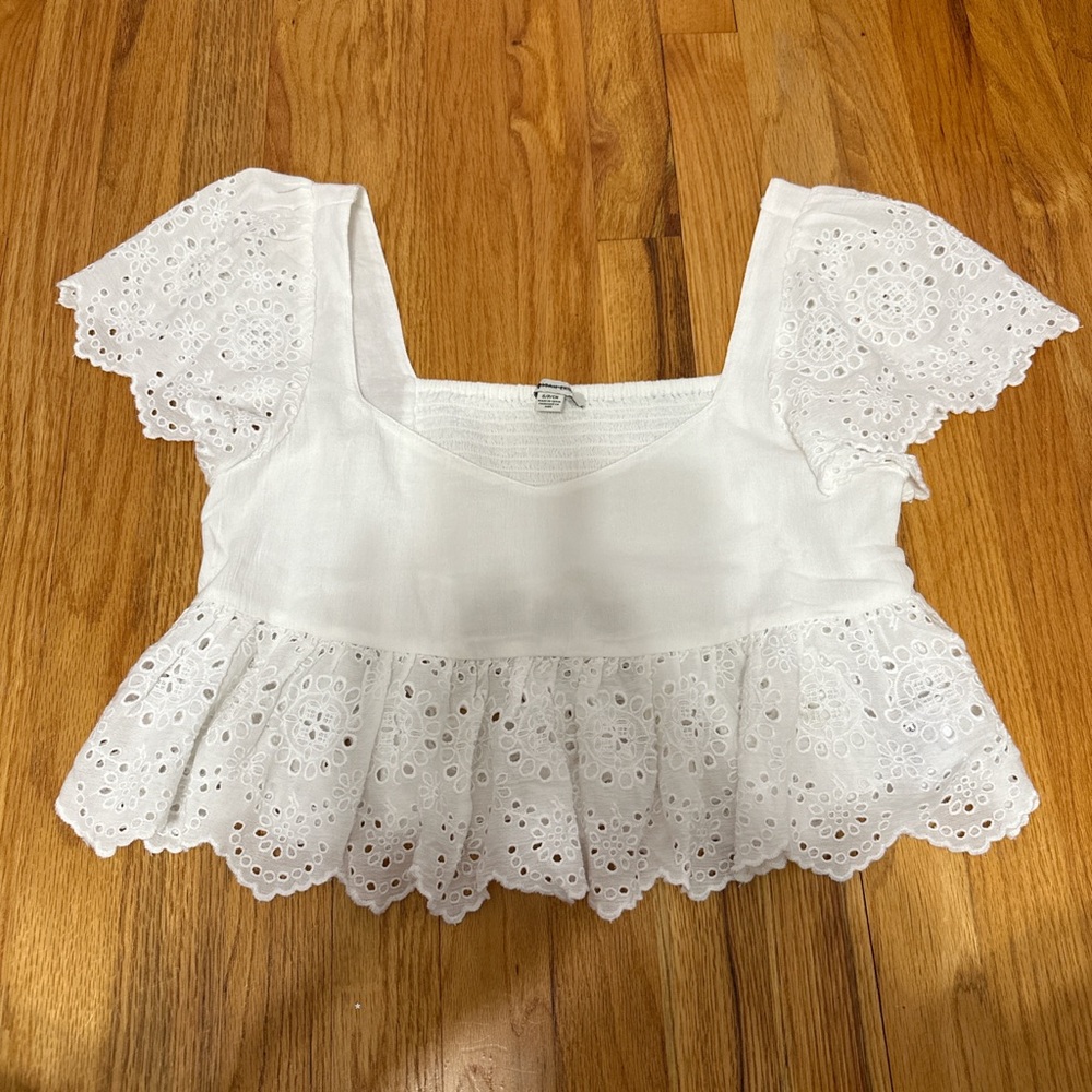 Babydoll style cropped white shirt with eyelet details